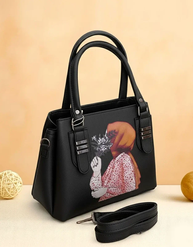 Black faux-leather crossbody bag with gold zip-top and unique Hijabi Girl print artwork